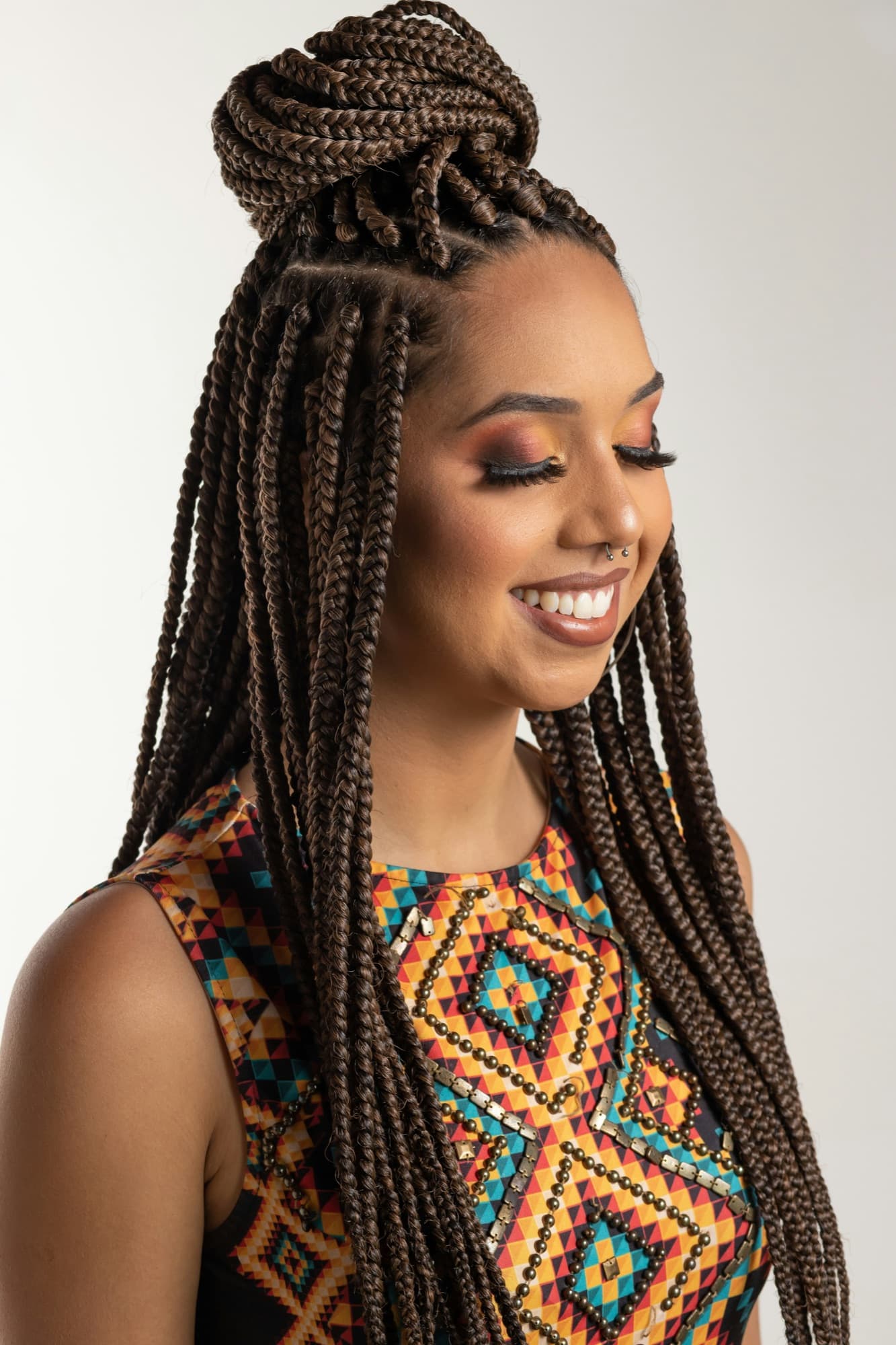 Smiling woman with box braids gathered in a bun